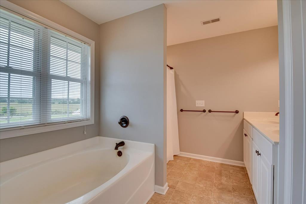 1673 Coleman Bridge Road Wagener, SC 29164 - Photo 22 of 45 a bathroom with a bathtub and a window