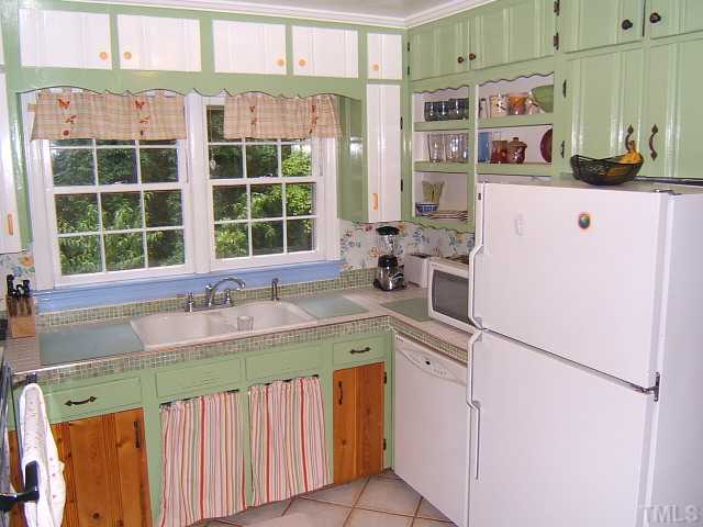 1213 Lorimer Road Raleigh, NC 27606 - Photo 16 of 20 Kitchen with tile floors & a view of the back yard.
