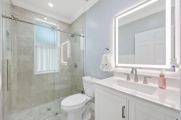 a bathroom with a sink toilet and shower