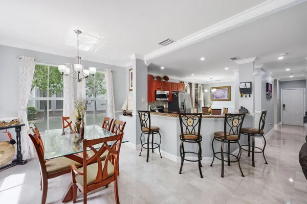 a dining room with furniture a chandelier and window
