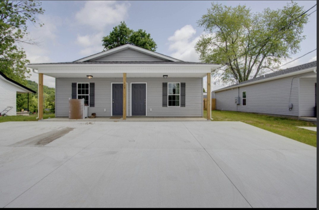 a front view of a house with a garden and garage