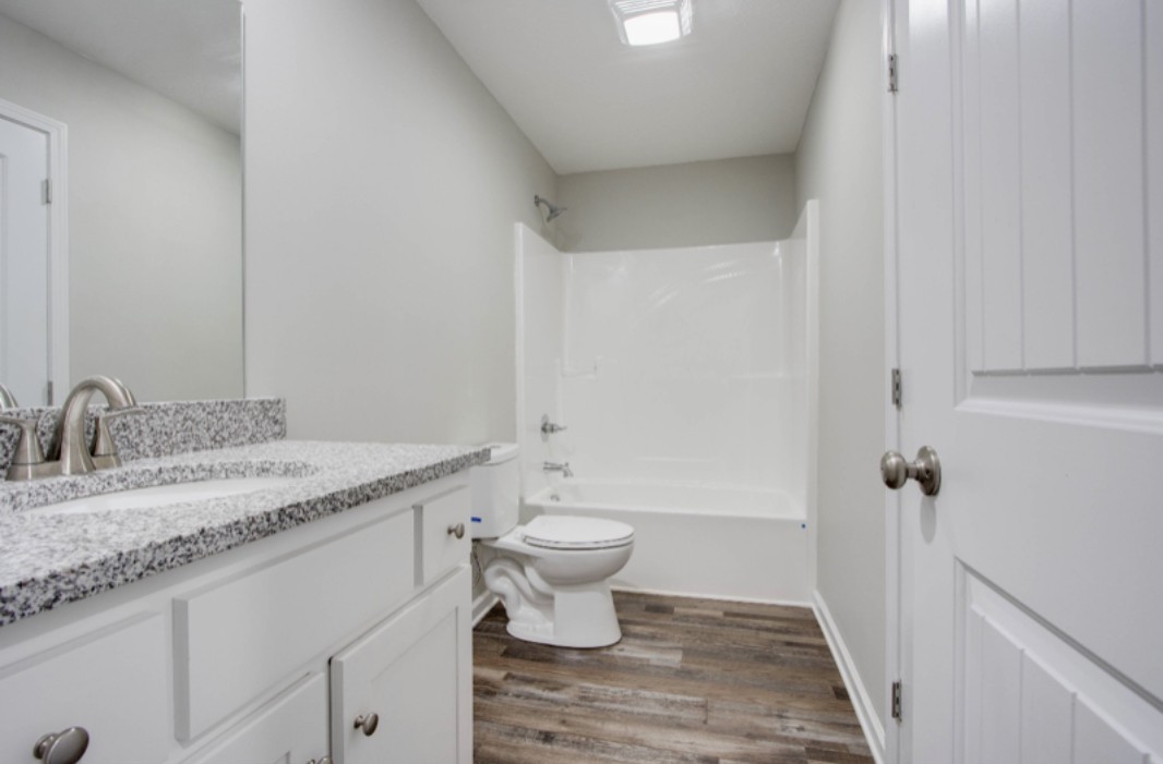 113 Bright Avenue Carthage, TN 37030 - Photo 14 of 14 a bathroom with a granite countertop sink a toilet and a mirror