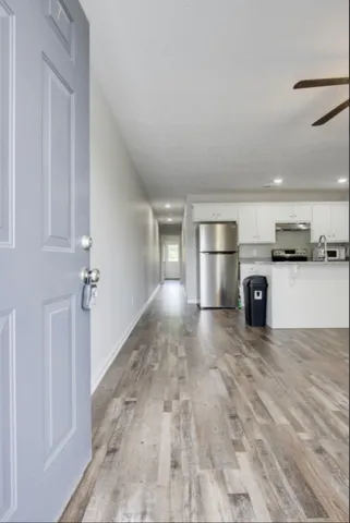 a view of a kitchen with a sink an oven and refrigerator