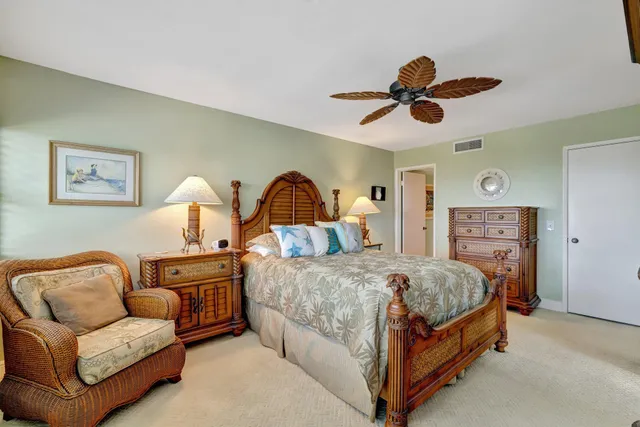 a bedroom with a bed and a potted plant