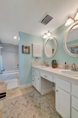 a kitchen with a refrigerator and a sink