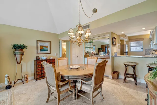 a view of a dining room with furniture and chandelier