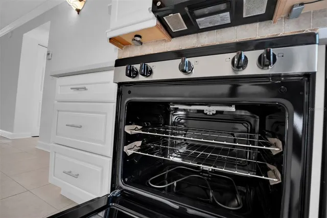 a stove top oven sitting inside of a kitchen