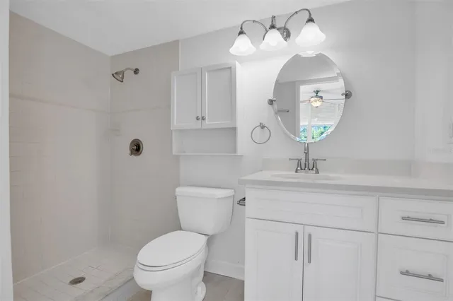 a bathroom with a toilet a sink and mirror