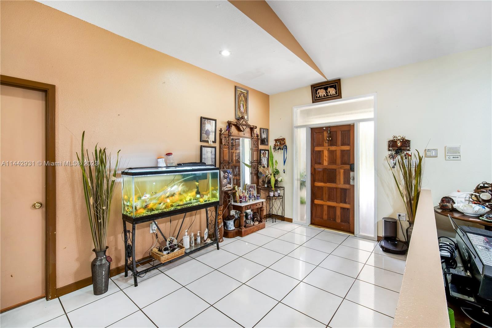 18475 Southwest 206th Street Miami, FL 33187 - Photo 11 of 49 a view of an entryway with workspace and bedroom