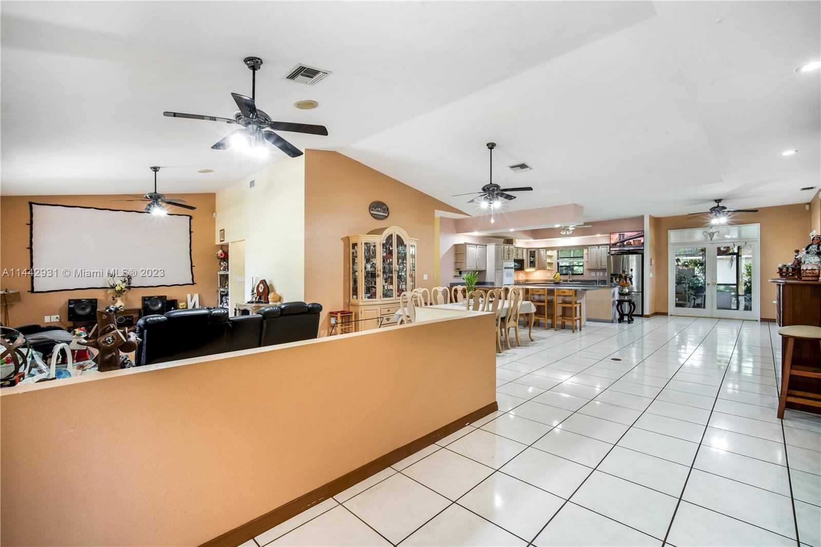 18475 Southwest 206th Street Miami, FL 33187 - Photo 12 of 49 a living room with couches a dining table and chairs with kitchen view