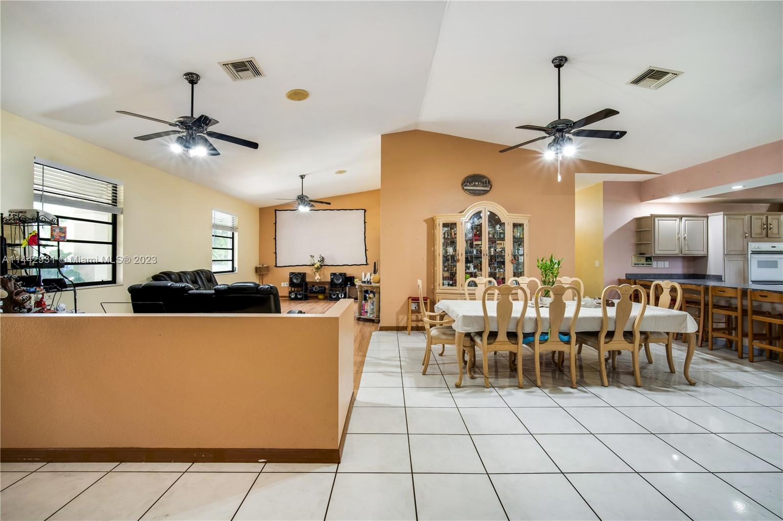 18475 Southwest 206th Street Miami, FL 33187 - Photo 13 of 49 a living room with lots of furniture and a chandelier