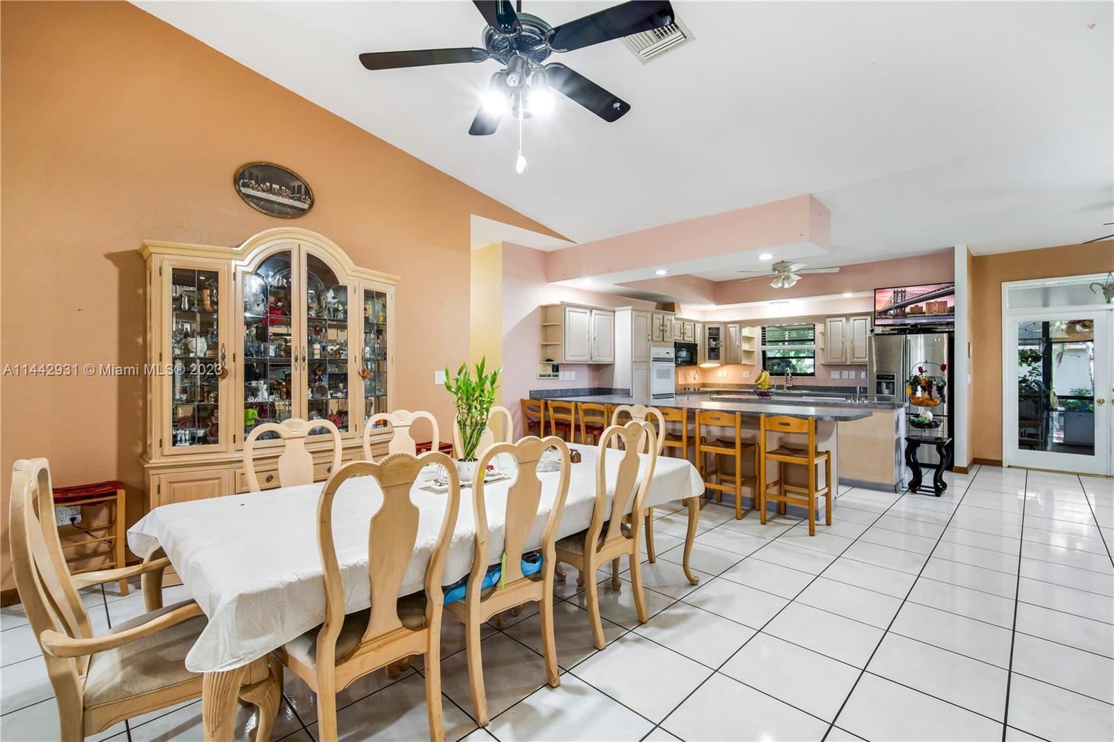 18475 Southwest 206th Street Miami, FL 33187 - Photo 16 of 49 a dining room with stainless steel appliances kitchen island granite countertop a dining table and chairs
