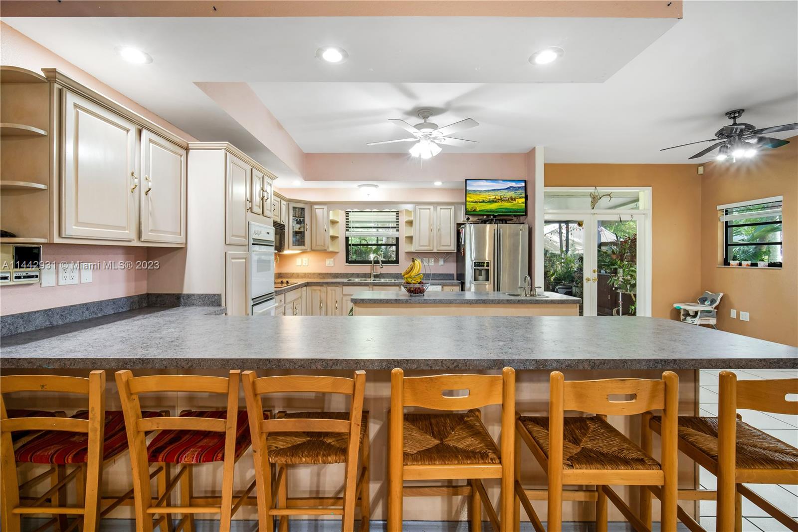 18475 Southwest 206th Street Miami, FL 33187 - Photo 18 of 49 a view of a kitchen with granite countertop a window and stainless steel appliances