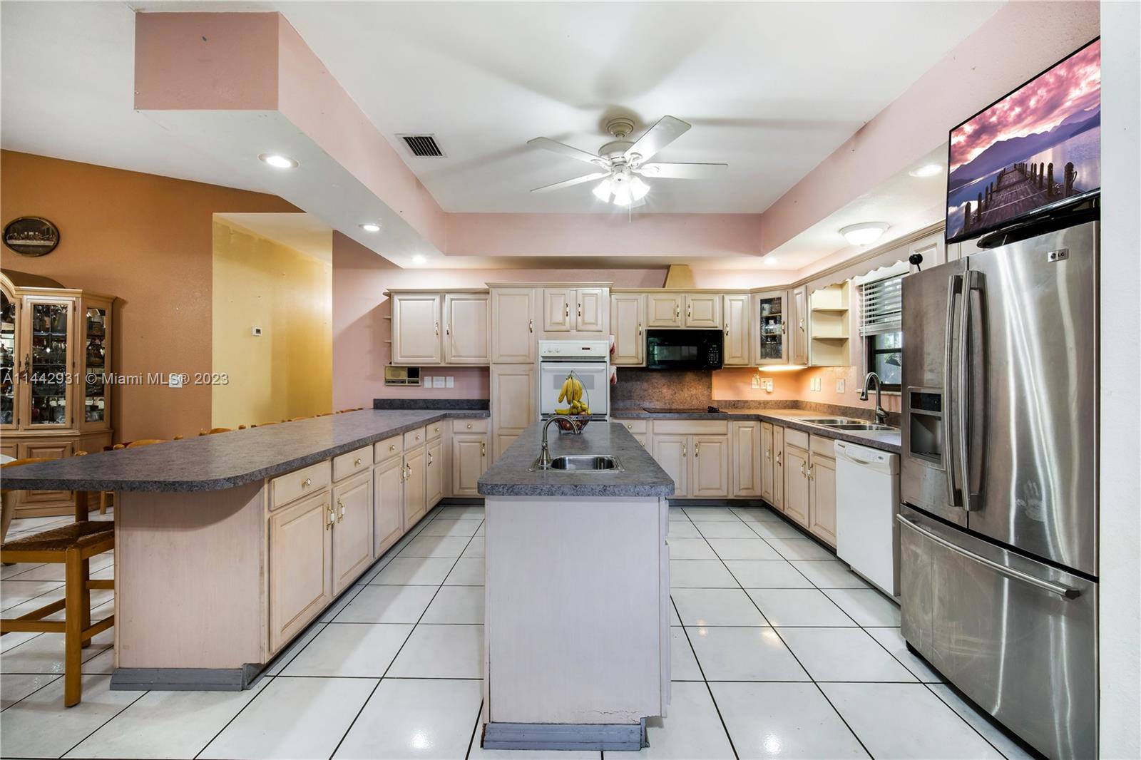 18475 Southwest 206th Street Miami, FL 33187 - Photo 20 of 49 a kitchen with stainless steel appliances a refrigerator sink and microwave