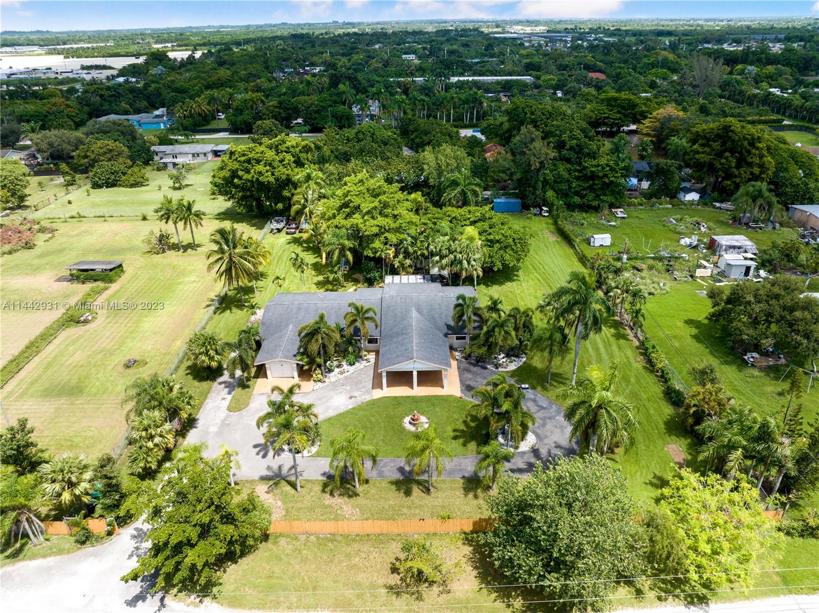 18475 Southwest 206th Street Miami, FL 33187 - Photo 2 of 49 an aerial view of residential house with outdoor space and trees all around