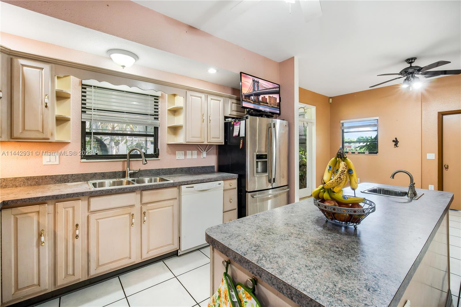 18475 Southwest 206th Street Miami, FL 33187 - Photo 21 of 49 a kitchen with stainless steel appliances granite countertop a sink and a refrigerator