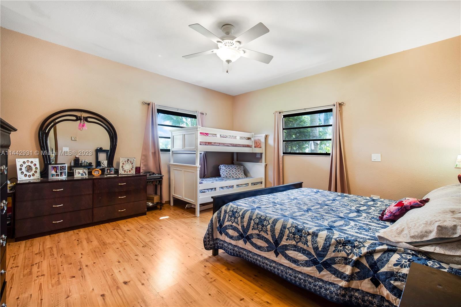 18475 Southwest 206th Street Miami, FL 33187 - Photo 23 of 49 a bedroom with a bed and a dresser