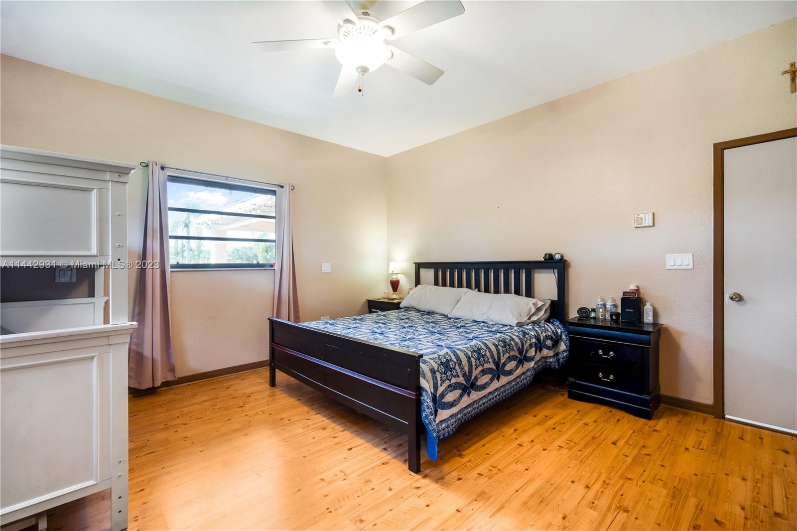 18475 Southwest 206th Street Miami, FL 33187 - Photo 24 of 49 a bedroom with a bed and a window