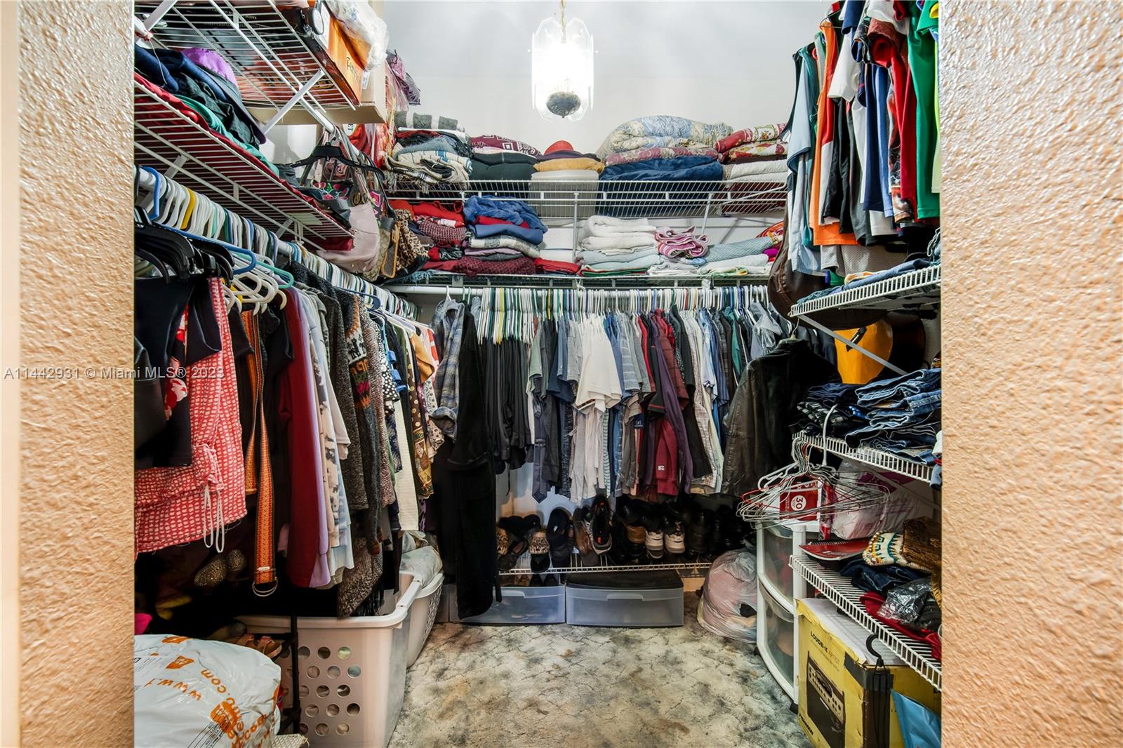 18475 Southwest 206th Street Miami, FL 33187 - Photo 27 of 49 a view of walk in closet with clothes and shoes
