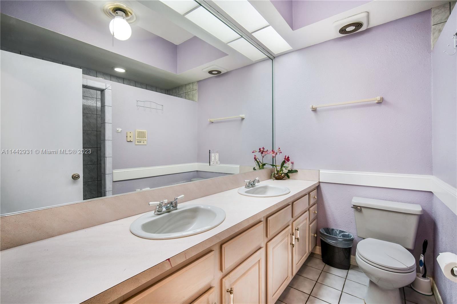 18475 Southwest 206th Street Miami, FL 33187 - Photo 28 of 49 a bathroom with a sink toilet and a mirror