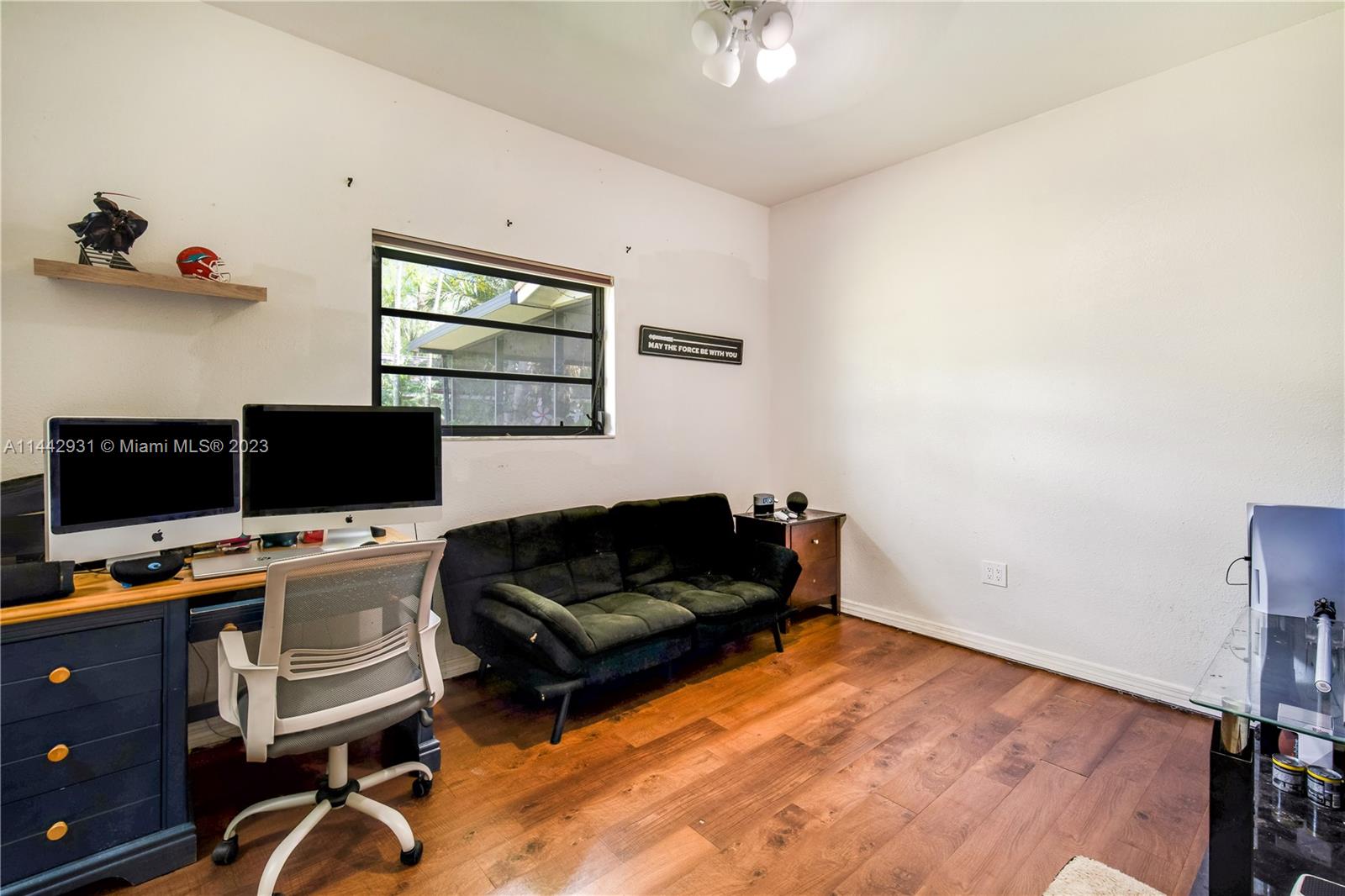 18475 Southwest 206th Street Miami, FL 33187 - Photo 29 of 49 a livingroom with workspace and a couch