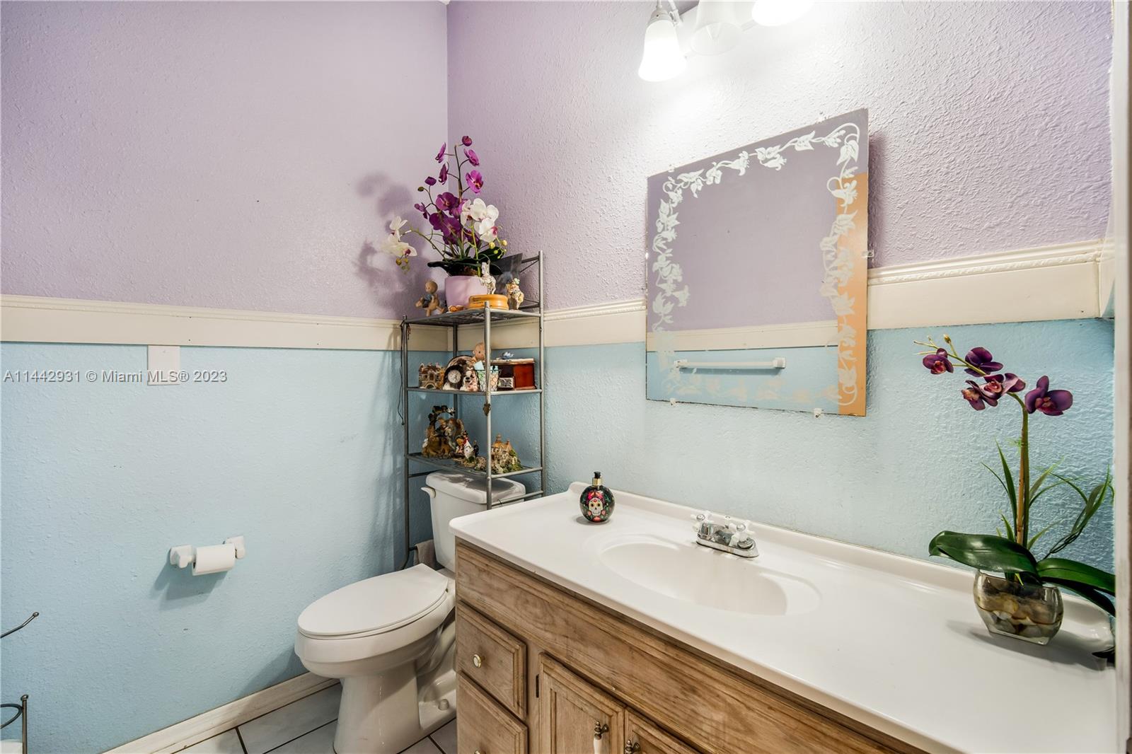 18475 Southwest 206th Street Miami, FL 33187 - Photo 32 of 49 a bathroom with a sink a toilet and a mirror
