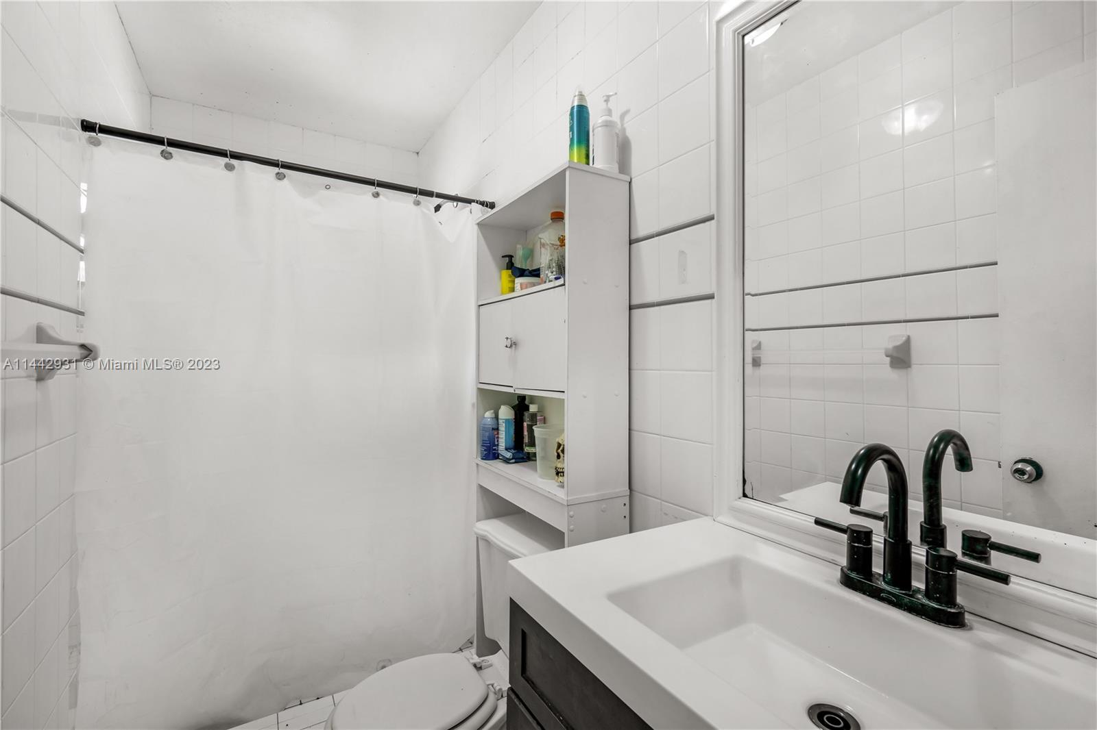 18475 Southwest 206th Street Miami, FL 33187 - Photo 35 of 49 a bathroom with a sink and a mirror