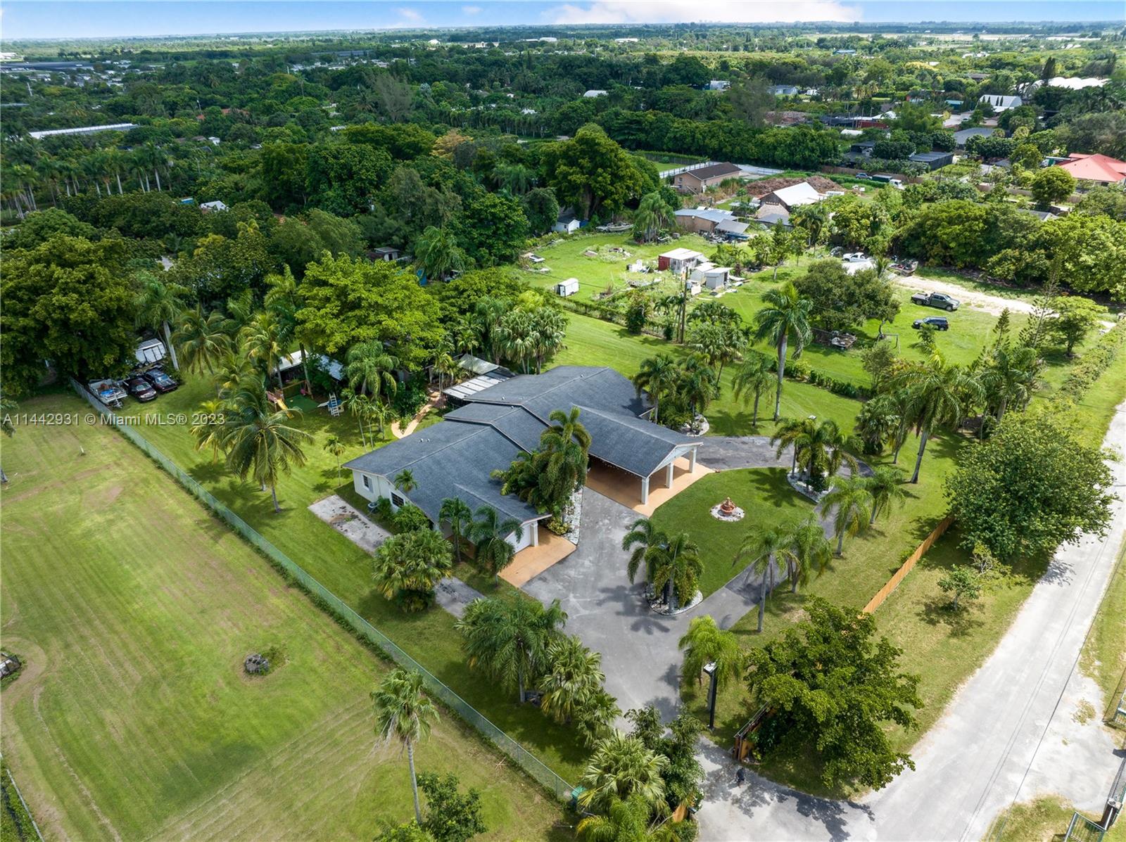18475 Southwest 206th Street Miami, FL 33187 - Photo 4 of 49 a view of a garden with a lake