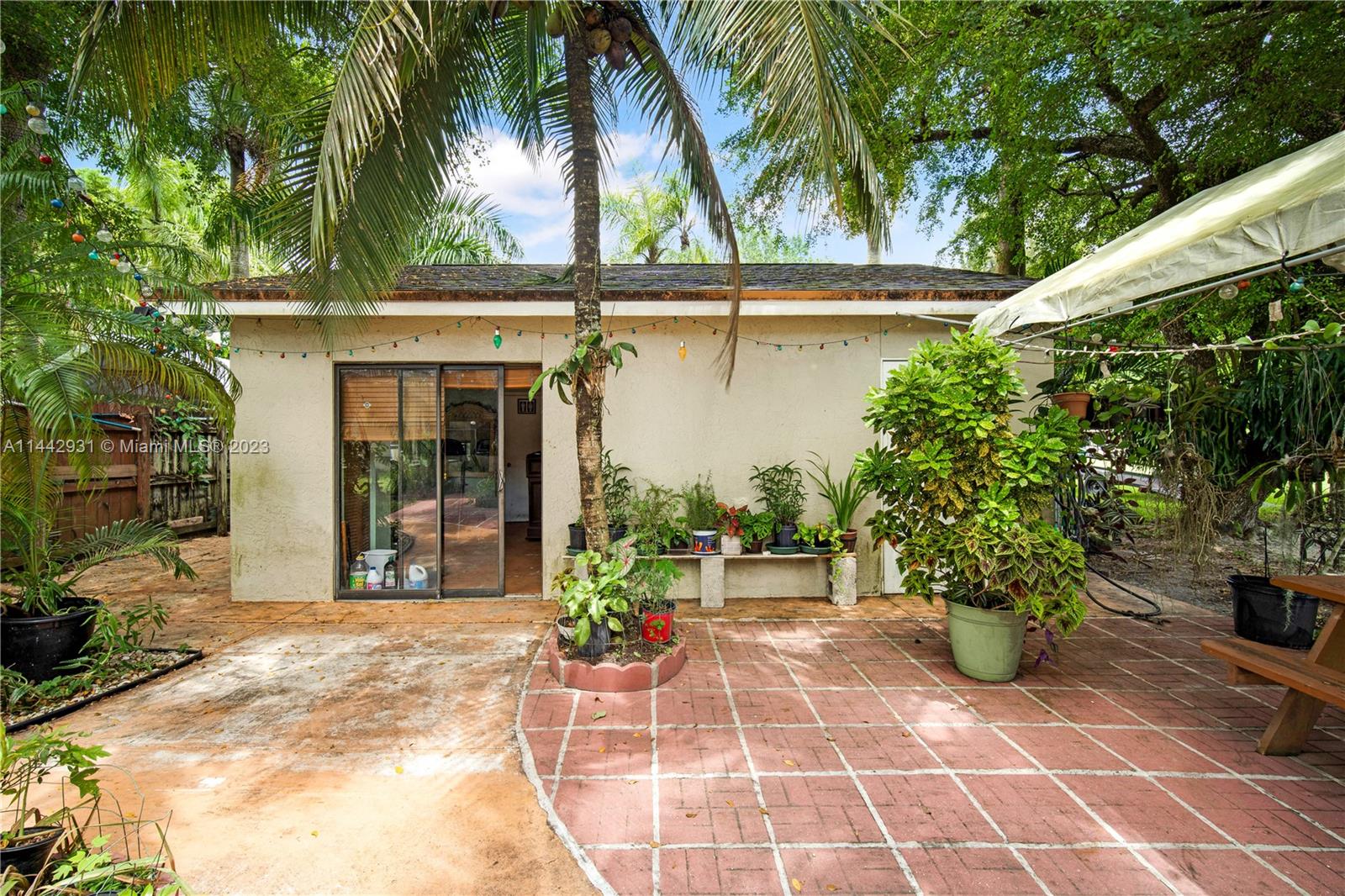 18475 Southwest 206th Street Miami, FL 33187 - Photo 42 of 49 a view of a chairs and table in the patio with a fire pit