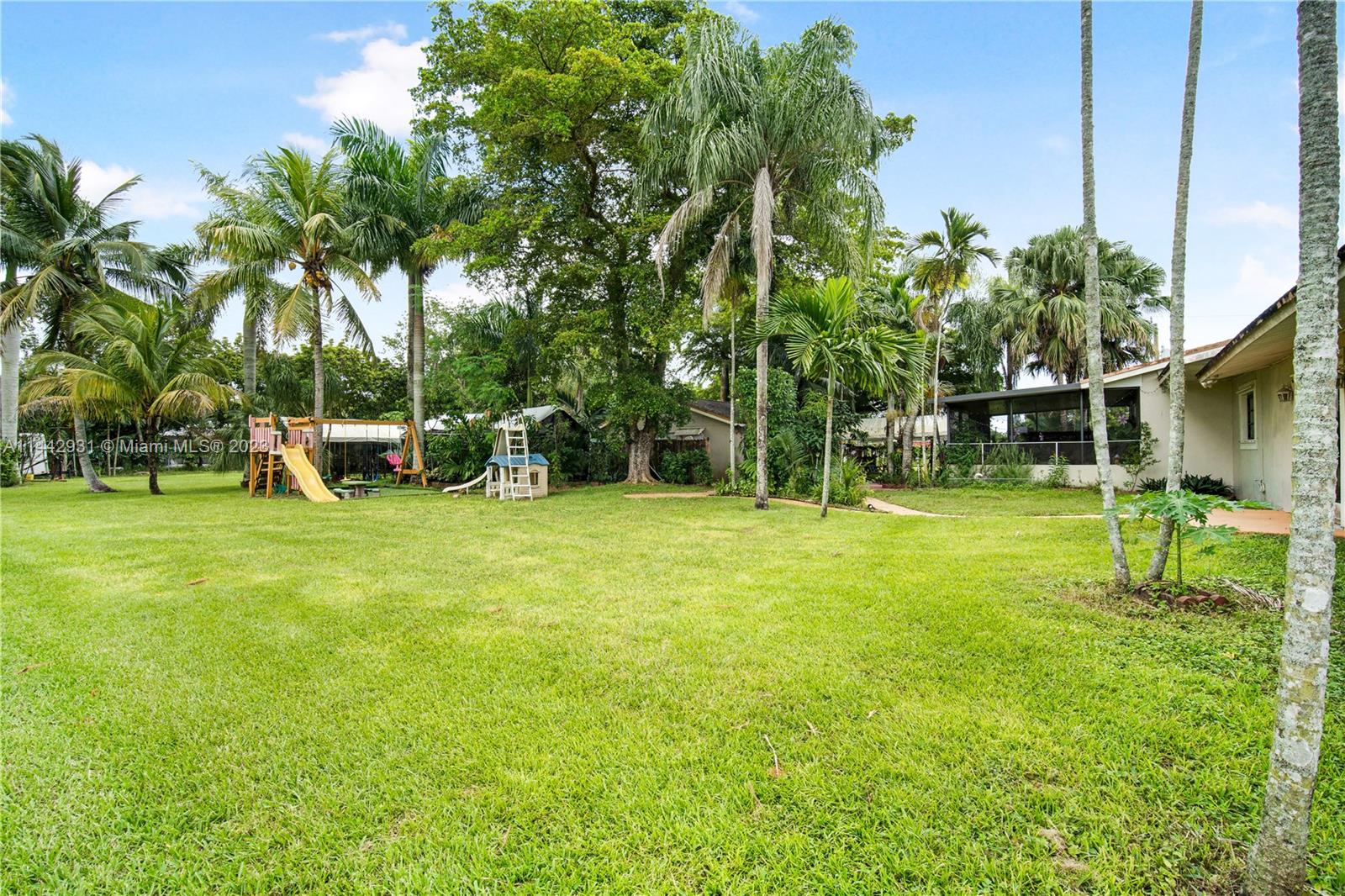 18475 Southwest 206th Street Miami, FL 33187 - Photo 43 of 49 a view of a park with swings