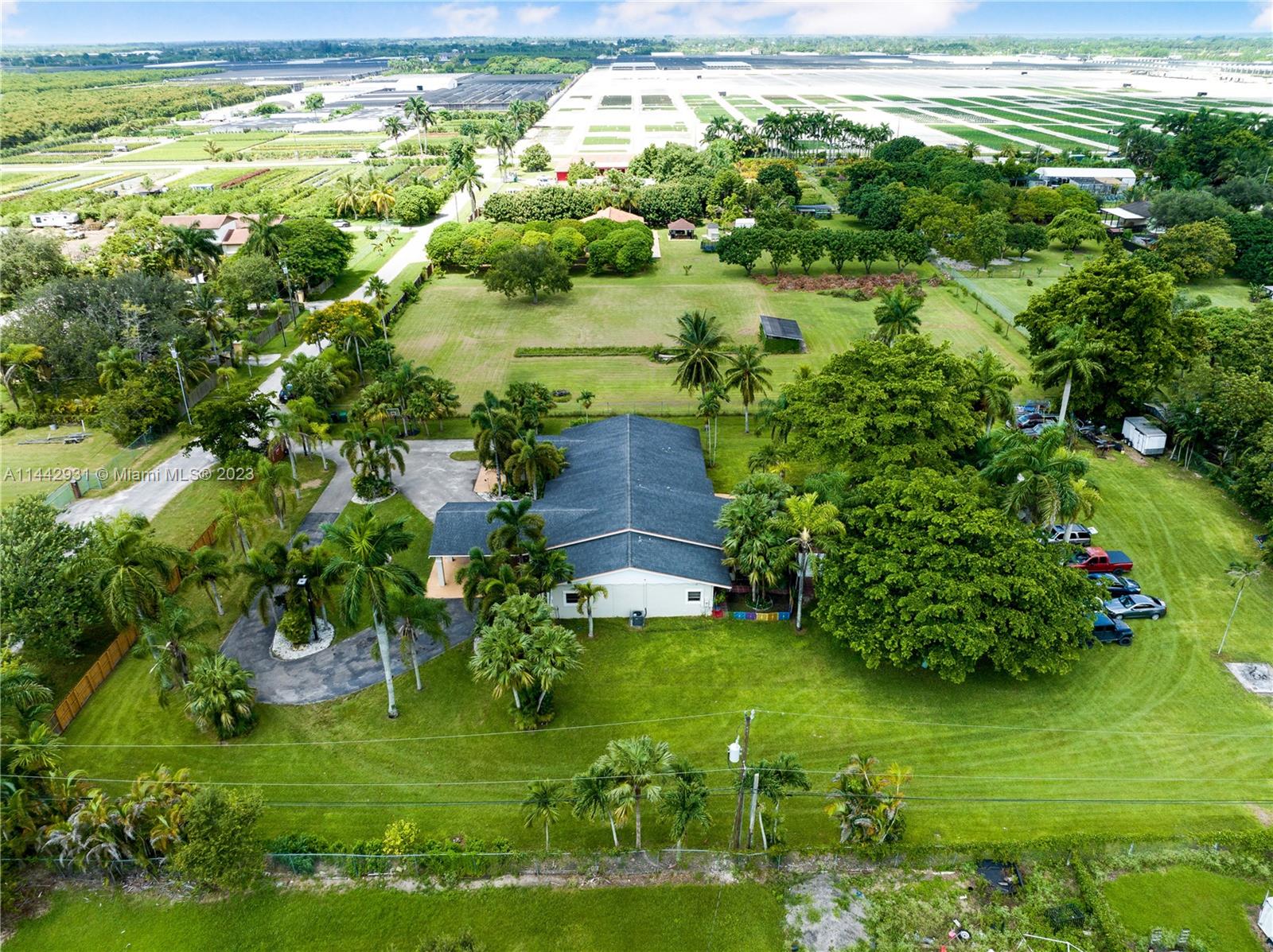 18475 Southwest 206th Street Miami, FL 33187 - Photo 49 of 49 a backyard of a house with a yard and plants