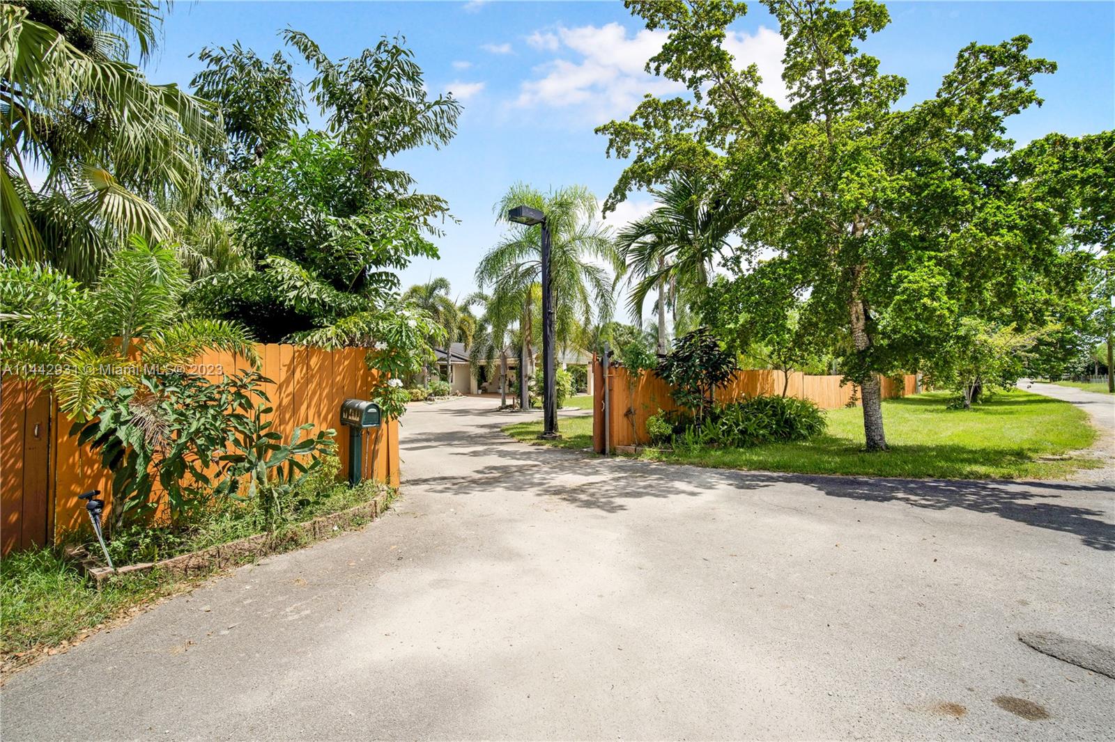 18475 Southwest 206th Street Miami, FL 33187 - Photo 6 of 49 a view of a street with a trees