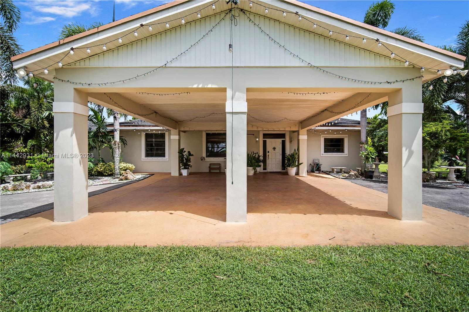 18475 Southwest 206th Street Miami, FL 33187 - Photo 10 of 49 a view of a patio with table and chairs under an umbrella