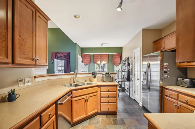 a kitchen with stainless steel appliances kitchen island granite countertop a sink and cabinets