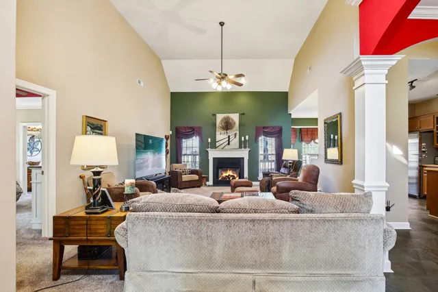 a living room with fireplace furniture and a chandelier