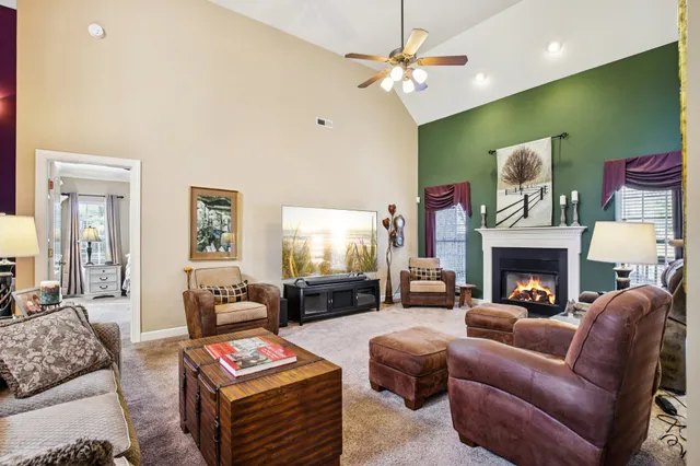 a living room with furniture a fireplace with projector screen