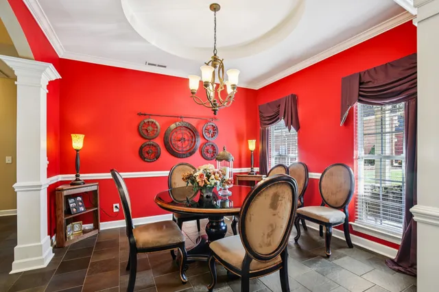 a dining room with furniture and window