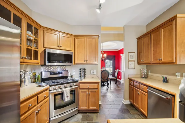 a kitchen with stainless steel appliances granite countertop a sink stove and microwave