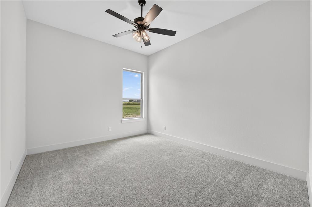 517 Longhorn Lane Springtown, TX 76082 - Photo 30 of 39 Spare room with carpet floors and a ceiling fan