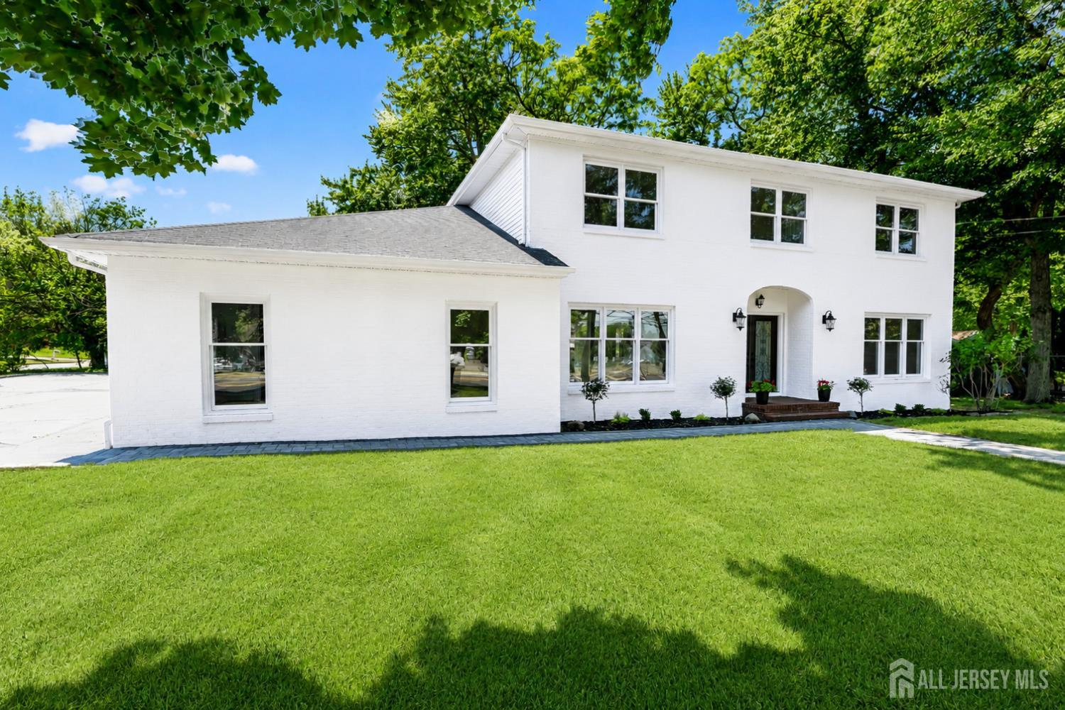 975 Inman Avenue Edison, NJ 08820 - Photo 3 of 61 a front view of a house with yard and trees