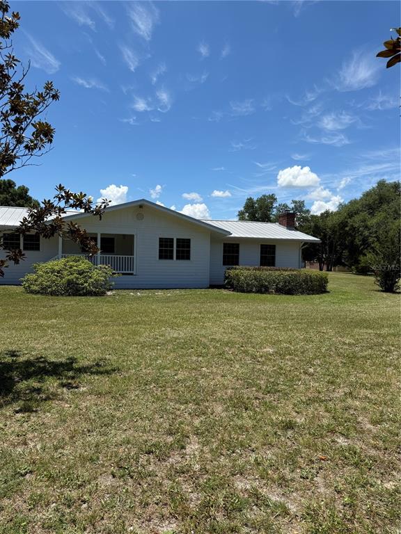 7390 South Mc Alpin Road McAlpin, FL 32062 - Photo 29 of 53 a front view of house with yard and trees in the background