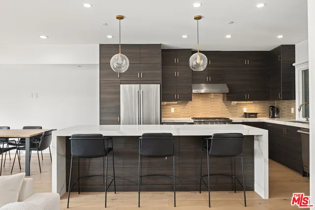 a kitchen with a counter space cabinets and appliances