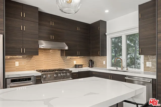 a kitchen with a stove a sink and a cabinets