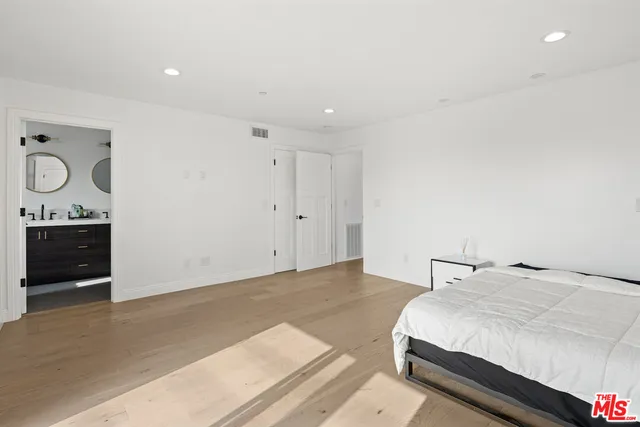 a bedroom with a bed and cabinets