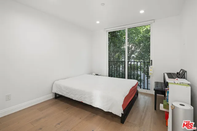 a bed sitting in a room next to a window