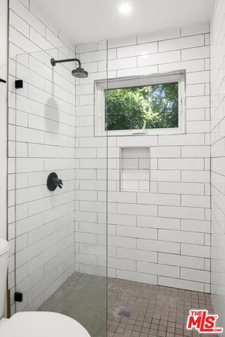 a bathroom with a toilet and a shower