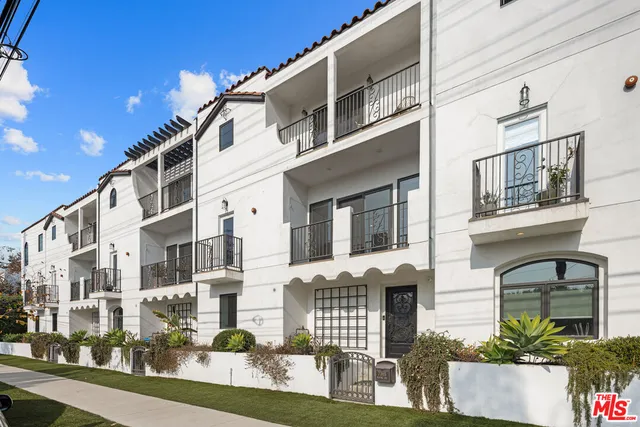 a front view of a building with a garden