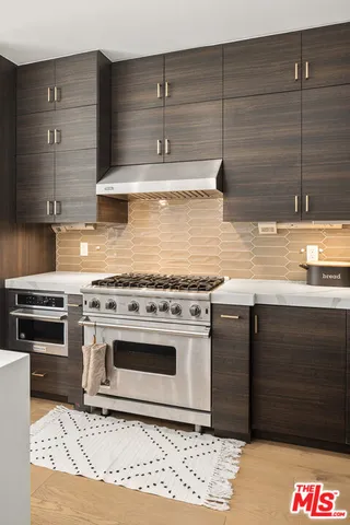 a kitchen with stainless steel appliances granite countertop a stove and a cabinets