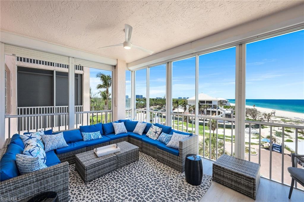 269 Barefoot Beach Boulevard, Unit 403 Bonita Springs, FL 34134 - Photo 19 of 27 Sunroom featuring an outdoor living space, view of water and beach, ceiling fan, a textured ceiling, and wood finished floors