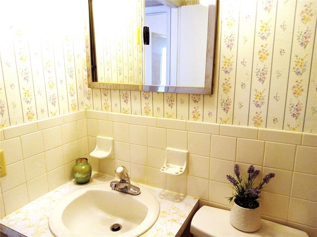2427 Rhodesian Drive, Unit 11 Clearwater, FL 33763 - Photo 23 of 44 a bathroom with a sink and a mirror